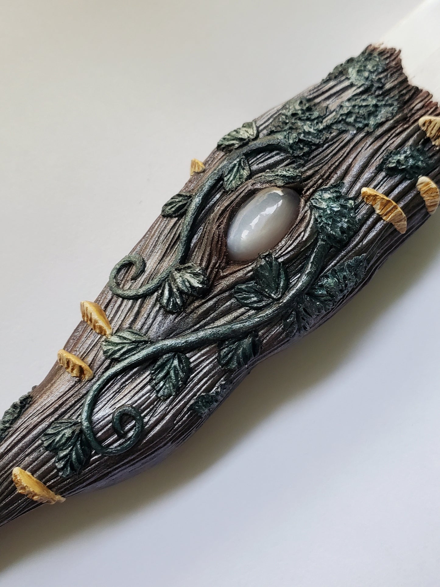 close up of middle of handle showing gray moonstone