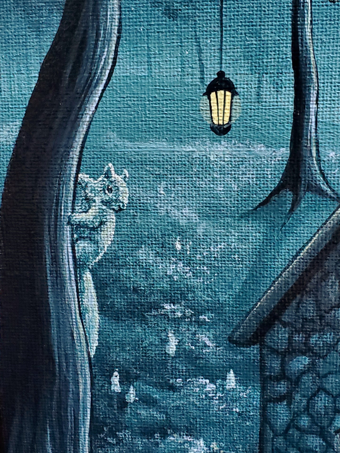 close up of the squirrel climbing up the tree and the lantern hanging just above its head.